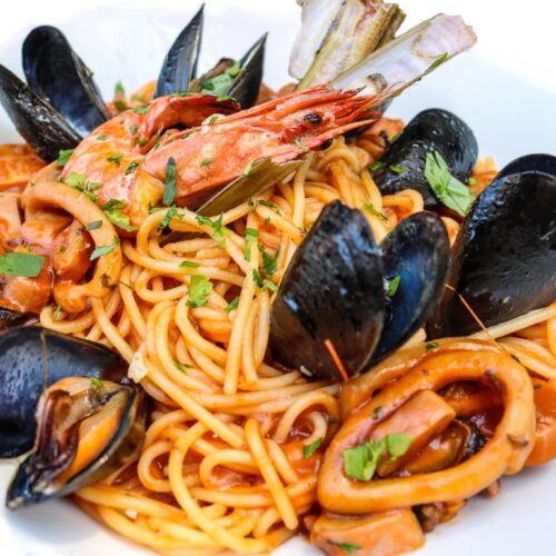 Spaghetti served with a variety of seafood and shellfish, cooked in garlic, mixed herbs, tomato sauce, white wine and homemade olive oil